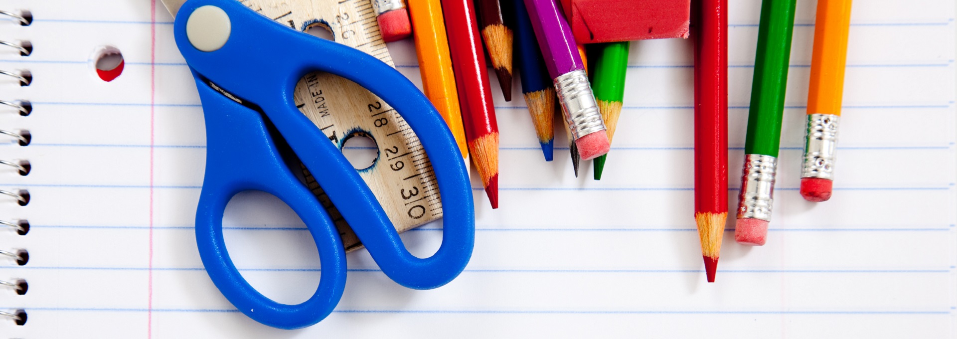 Assorted school supplie with a notebooks, pencils, pens, scissors etc.